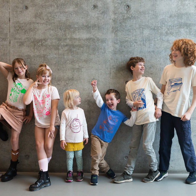 six children wearing their own designed t-shirt
