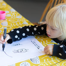 Load image into Gallery viewer, Girl drawing her design for her own t-shirt